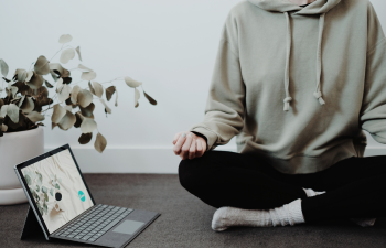 Woman Meditating with Laptop