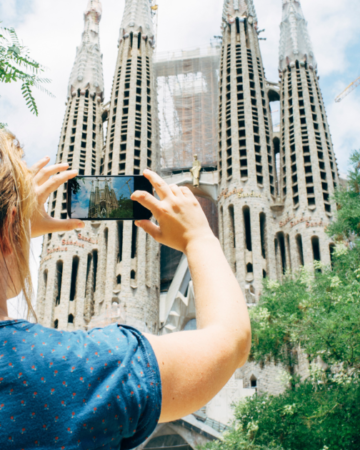 Woman tourist taking a photo of building